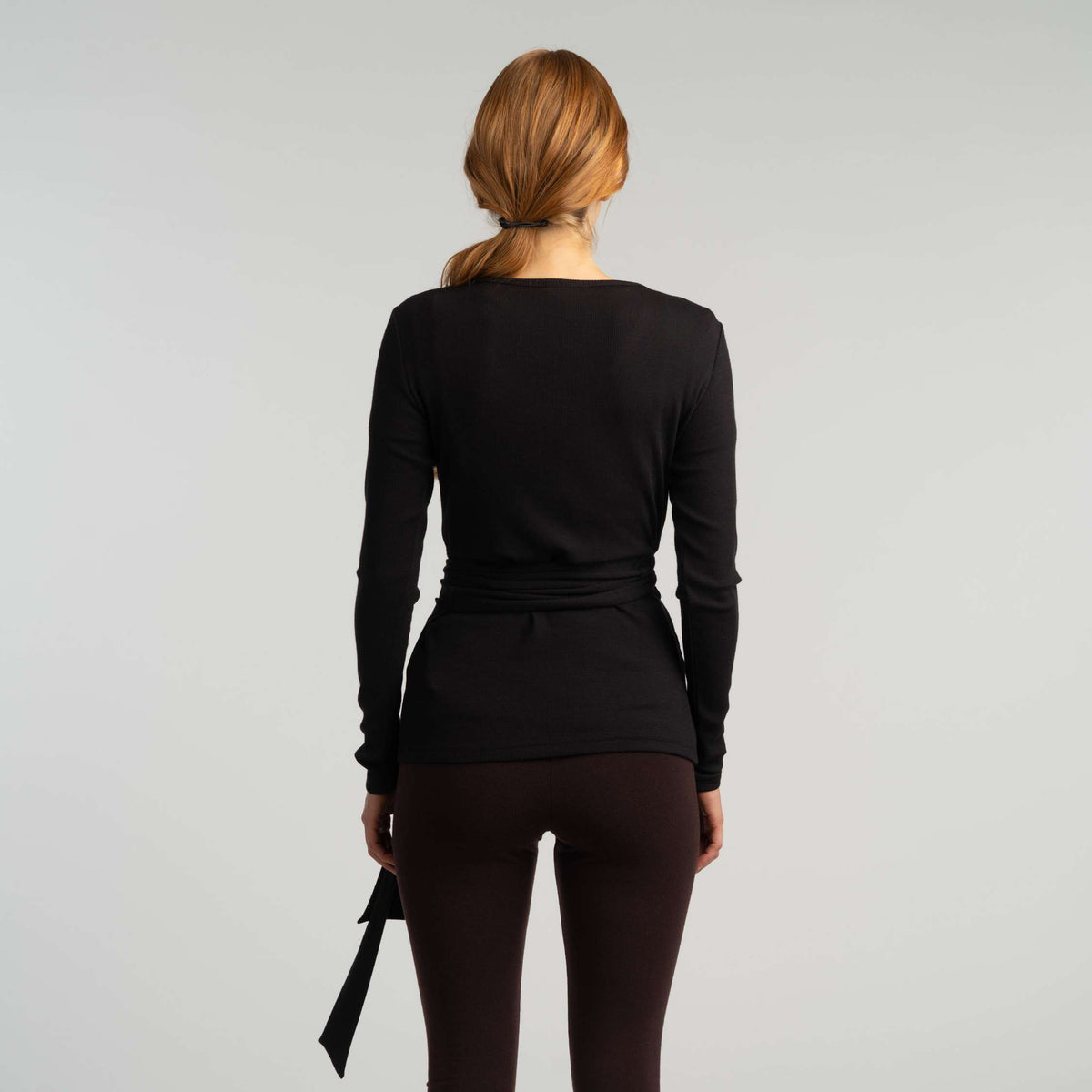 North Outdoor Lou women's merino wrap top in black, mulesing-free merino wool. Designed in Finland. - Model is 173 cm and wears size S